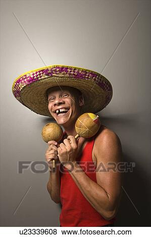 Portrait of a Mid-adult Caucasian male wearing sombrero holding maracas. View Large Photo Image Stock Photo - Portrait of a Mid-adult Caucasian male wearing sombrero holding maracas.. Fotosearch