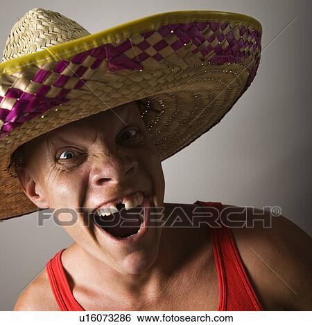 Portrait of a mid-adult Caucasian male wearing sombrero with with funny expression. View Large Photo Image Stock Photograph - Portrait of a mid-adult Caucasian male wearing sombrero with with funny expression.. Fotosearch