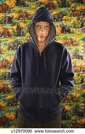 Stock Photography - Portrait of a Mid-adult Caucasian male wearing a hoodie.. Fotosearch
