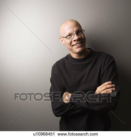 Stock Image - Portrait of man with crossed arms. Fotosearch