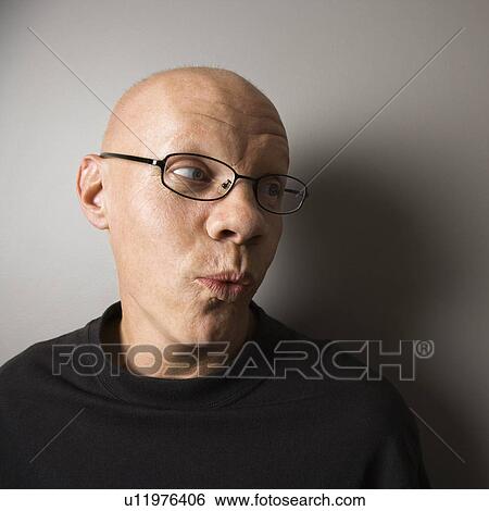 Stock Photograph - Portrait of mid-adult Caucasian male with puckered lips.. Fotosearch