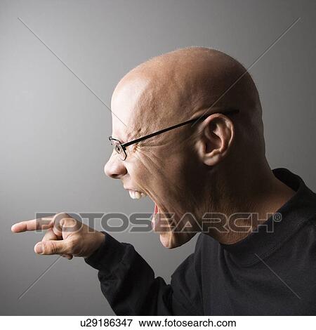 Profile portrait of mid-adult male screaming and pointing View Large Photo Image Stock Photo - Profile portrait of mid-adult male screaming and pointing. Fotosearch