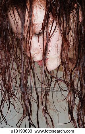 Close up of young woman with long red wet hair View Large Photo Image Stock Image - Close up of young woman with long red wet hair. Fotosearch