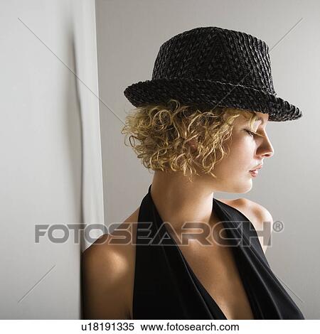Profile of young adult woman wearing fedora hat with eyes closed View Large Photo Image Stock Photography - Profile of young adult woman wearing fedora hat with eyes closed. Fotosearch