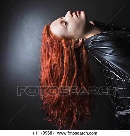 Woman wearing leather jacket leaning back in chair View Large Photo Image Stock Photo - Woman wearing leather jacket leaning back in chair. Fotosearch