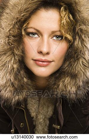 Young adult woman wearing coat with fur hood looking at viewer View Large Photo Image Stock Image - Young adult woman wearing coat with fur hood looking at viewer. Fotosearch