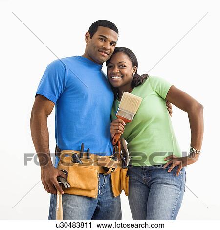 Stock Image - Male and female couple with home repair tools. Fotosearch