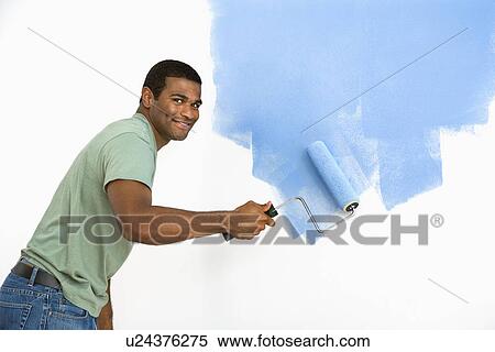 Man painting wall blue smiling View Large Photo Image Stock Photography - Man painting wall blue smiling. Fotosearch