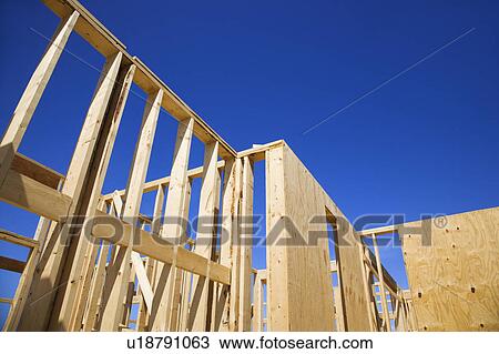 Wooden framework of new construction with blue sky in background. View Large Photo Image Stock Image - Wooden framework of new construction with blue sky in background.. Fotosearch