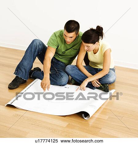 Attractive young adult couple looking at house plans. View Large Photo Image Stock Photography - Attractive young adult couple looking at house plans.. Fotosearch