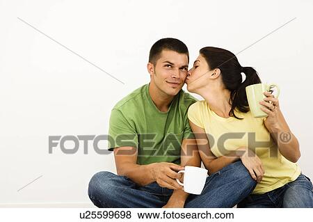 Couple sitting on floor drinking coffee View Large Photo Image Stock Photo - Couple sitting on floor drinking coffee. Fotosearch