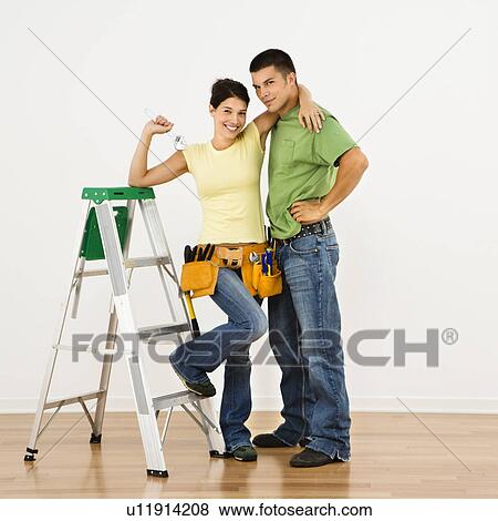 Couple with tools and ladder standing in home smiling. View Large Photo Image Stock Photo - Couple with tools and ladder standing in home smiling.. Fotosearch