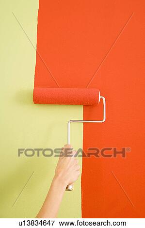 Female hand painting with red onto a green wall View Large Photo Image Stock Photo - Female hand painting with red onto a green wall. Fotosearch
