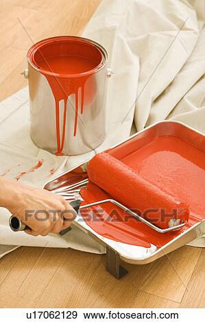 Hand holding paint roller in tray View Large Photo Image Stock Photo - Hand holding paint roller in tray . Fotosearch