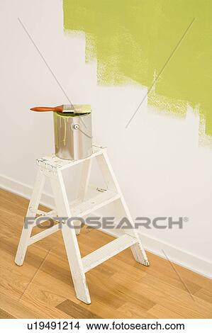 Paintbrush on can on top of step ladder with painted wall. View Large Photo Image Picture - Paintbrush on can on top of step ladder with painted wall.. Fotosearch