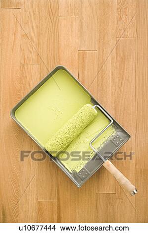 Still life of paint roller in tray on wood floor View Large Photo Image Picture - Still life of paint roller in tray on wood floor. Fotosearch