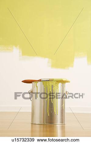 Stock Photo - Still life of paintbrush on paint can with painted wall.. Fotosearch