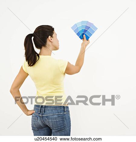 Woman trying to choose color for interior wall View Large Photo Image Stock Image - Woman trying to choose color for interior wall. Fotosearch