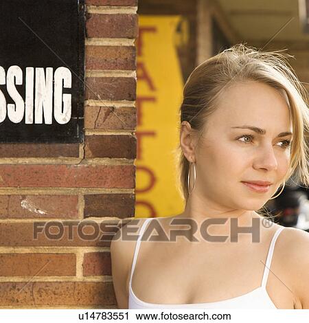 Attractive young Caucasian woman standing outside tattoo parlor. View Large Photo Image Stock Image - Attractive young Caucasian woman standing outside tattoo parlor.. Fotosearch