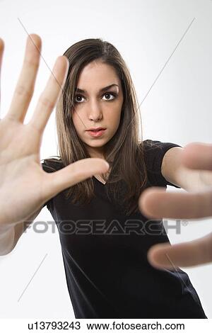 Stock Image - Female with hands in foreground. Fotosearch