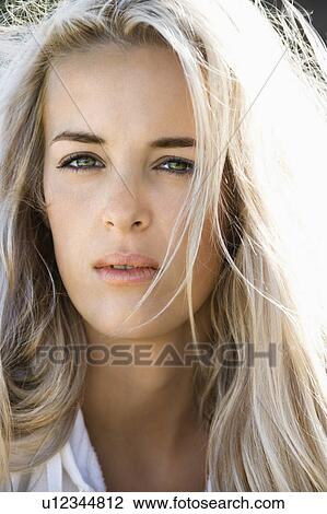 Stock Image - Head and shoulder portrait of pretty blond Caucasian woman.. Fotosearch
