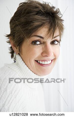 Stock Photo - Head and shoulder portrait of pretty Caucasian woman smiling.. Fotosearch