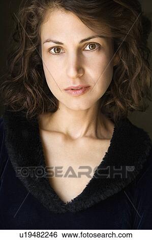 Stock Photograph - Head and shoulder portrait of pretty brunette woman.. Fotosearch