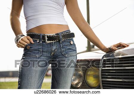 Midsection of young Caucasian woman standing beside automobile. View Large Photo Image Stock Photograph - Midsection of young Caucasian woman standing beside automobile.. Fotosearch