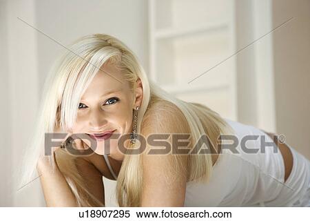 Portrait of attractive blonde Caucasian young adult woman smiling and looking at viewer. View Large Photo Image Stock Photography - Portrait of attractive blonde Caucasian young adult woman smiling and looking at viewer.. Fotosearch