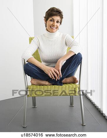 Portrait of pretty woman smiling sitting on modern chair. View Large Photo Image Stock Photograph - Portrait of pretty woman smiling sitting on modern chair.. Fotosearch