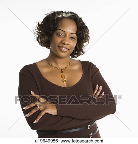 Stock Photograph - Portrait of pretty woman standing against white background. Fotosearch