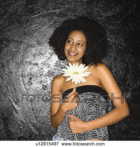 Woman holding flower View Large Photo Image Stock Photo - Woman holding flower. Fotosearch