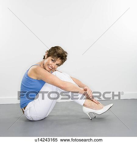 Woman sitting on floor and smiling View Large Photo Image Stock Photography - Woman sitting on floor and smiling. Fotosearch