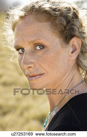 Stock Photo - Woman with curly hair looking . Fotosearch
