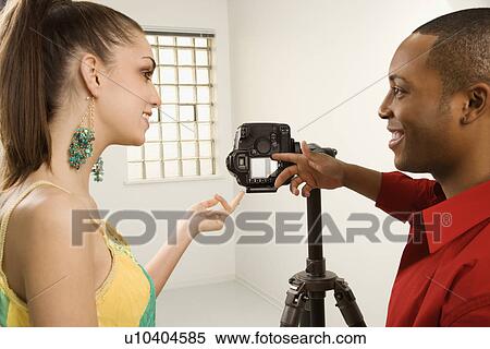 Adults previewing image on digital camera View Large Photo Image Stock Photography - Adults previewing image on digital camera. Fotosearch