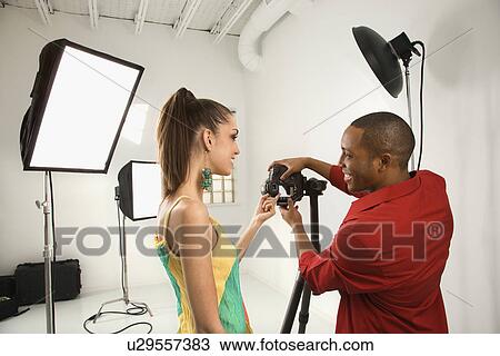 Man and woman previewing image on digital camera View Large Photo Image Stock Image - Man and woman previewing image on digital camera. Fotosearch
