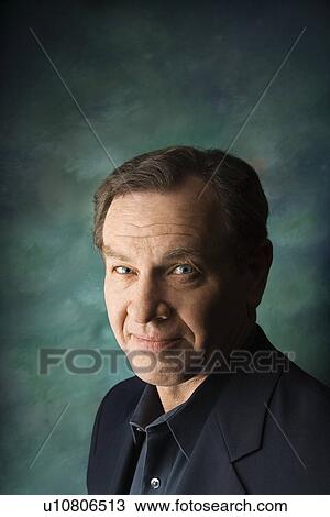 Stock Image - Mature man on studio background.. Fotosearch