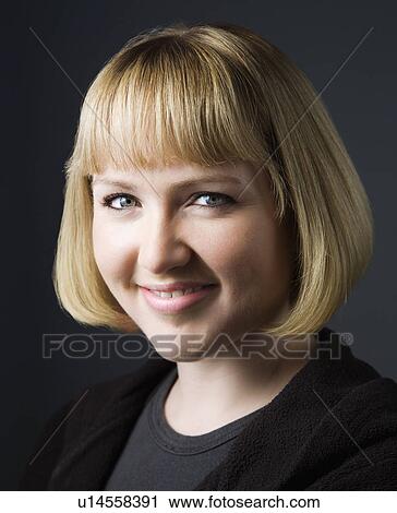 Stock Image - Portrait of woman smiling. Fotosearch