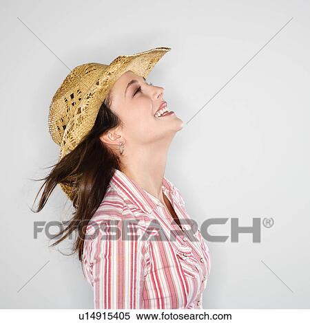 Profile of young woman wearing cowboy hat smiling with wind blowing hair. View Large Photo Image Stock Photography - Profile of young woman wearing cowboy hat smiling with wind blowing hair.. Fotosearch