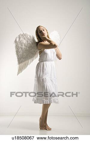 Stock Photo - Woman in white angel costume. Fotosearch
