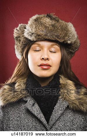 Woman wearing fur hat with eyes closed View Large Photo Image Stock Photo - Woman wearing fur hat with eyes closed. Fotosearch