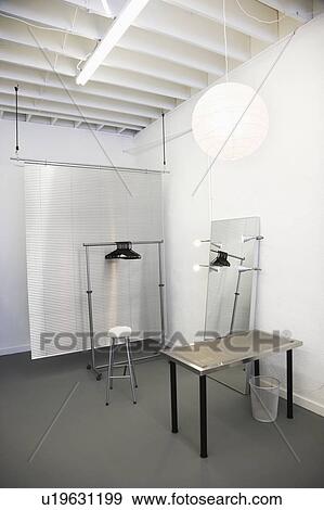 Workspace with table, chair, mirror, clothing rack and room divider. View Large Photo Image Stock Photo - Workspace with table, chair, mirror, clothing rack and room divider.. Fotosearch