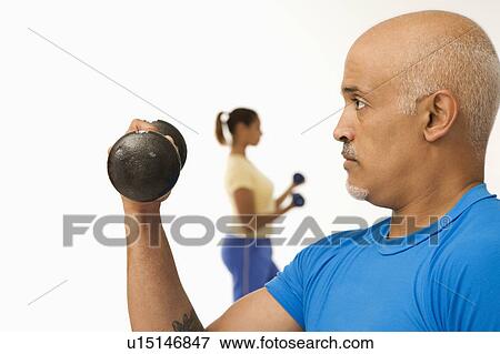 Stock Photo - Exercising using dumbbells. Fotosearch
