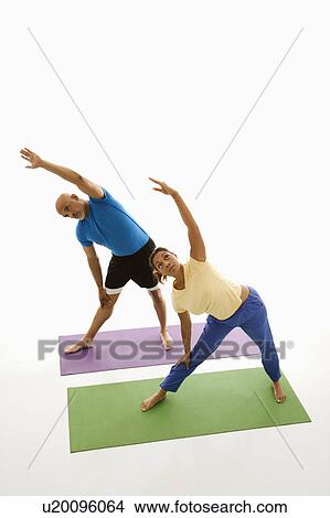 Man and woman standing on exercise mats View Large Photo Image Picture - Man and woman standing on exercise mats. Fotosearch
