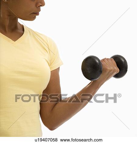 Woman doing arm curls looking at bicep View Large Photo Image Stock Photo - Woman doing arm curls looking at bicep. Fotosearch