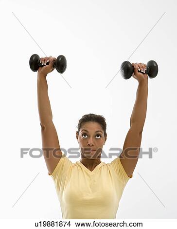 Woman holding dumbbells View Large Photo Image Picture - Woman holding dumbbells. Fotosearch