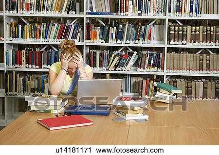 Despairing young woman in library View Large Photo Image Stock Image - Despairing young woman in library. Fotosearch