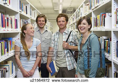 Four young students in a library View Large Photo Image Stock Image - Four young students in a library. Fotosearch