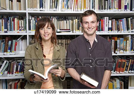 Portrait of two young people in library View Large Photo Image Stock Photo - Portrait of two young people in library. Fotosearch