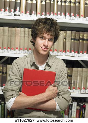 Portrait of young man with book View Large Photo Image Stock Photo - Portrait of young man with book. Fotosearch
